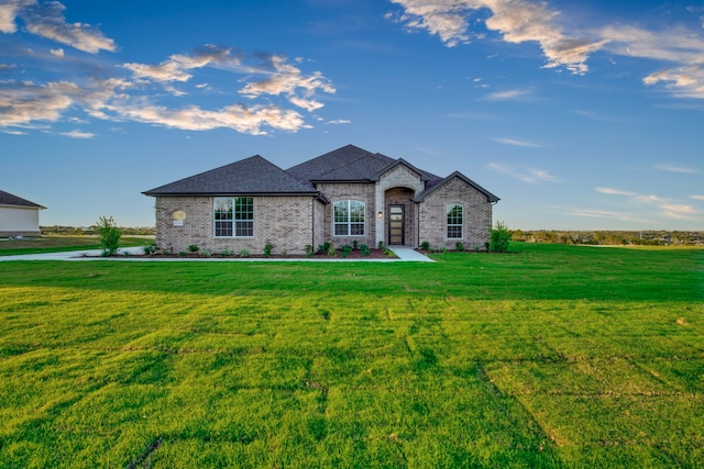 french provincial home featuring a front lawn