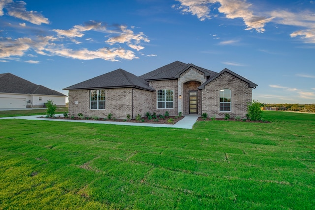 french country home featuring a front yard