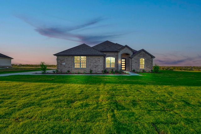 french provincial home featuring a yard