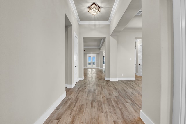 hall with light wood-type flooring and ornamental molding