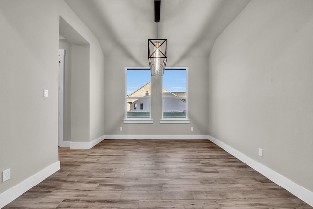 4201 Old Springtown Rd, Weatherford, TX 76085 - unfurnished dining area with wood finished floors, baseboards, and lofted ceiling