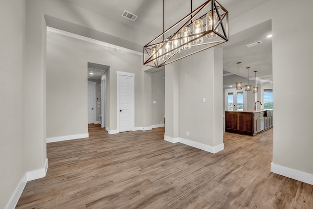 unfurnished dining area featuring light hardwood / wood-style flooring and sink