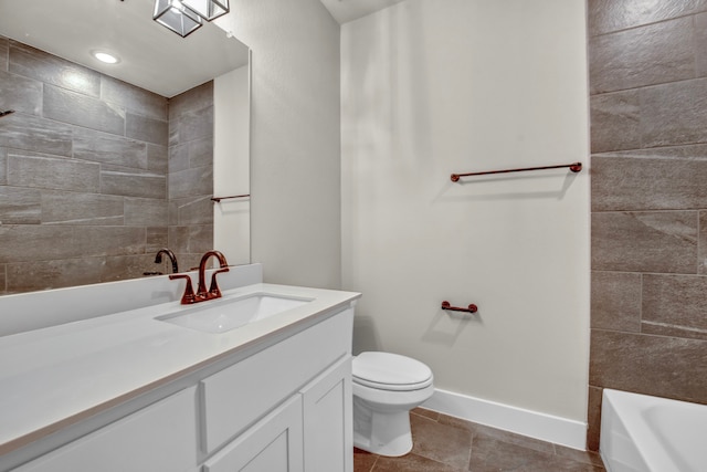 bathroom with toilet, a tub, vanity, and tile patterned floors