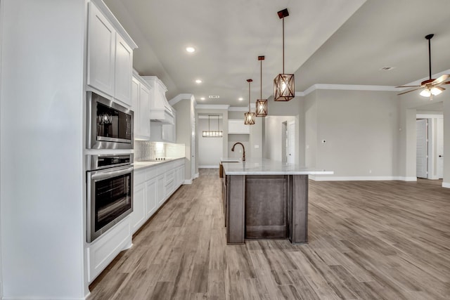 4201 Old Springtown Rd, Weatherford, TX 76085 - kitchen featuring oven, built in microwave, white cabinetry, light wood-style floors, and recessed lighting