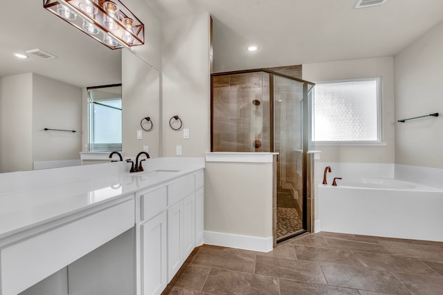 bathroom with vanity and independent shower and bath