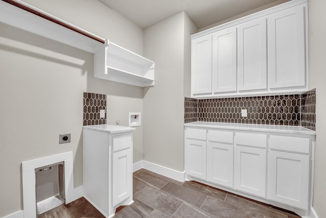 4201 Old Springtown Rd, Weatherford, TX 76085 - laundry area featuring electric dryer hookup, cabinet space, washer hookup, and baseboards