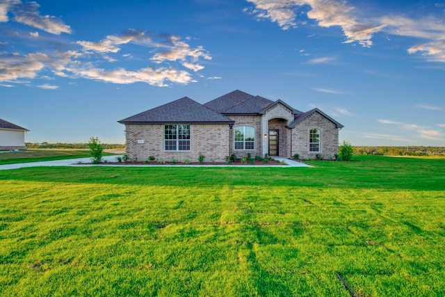 french country home featuring a front yard