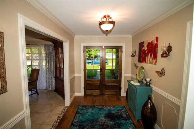 doorway to outside with french doors, dark tile floors, and crown molding