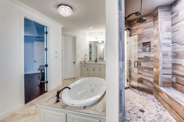 bathroom with crown molding, a stall shower, vanity, a whirlpool tub, and baseboards