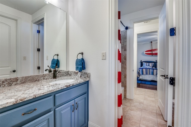 full bath with tile patterned flooring, visible vents, baseboards, and vanity