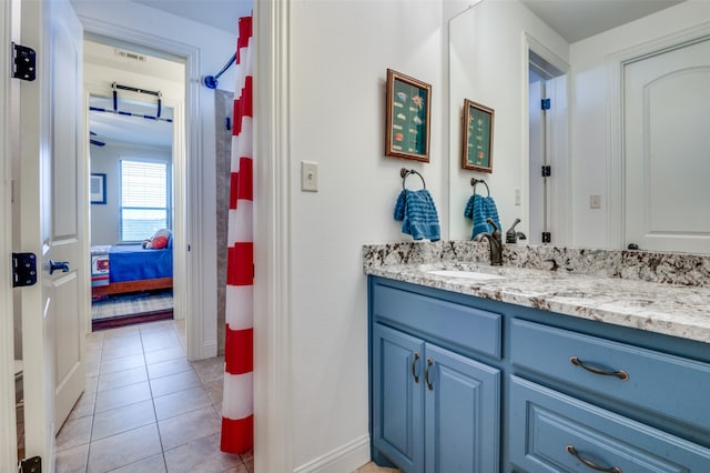 bathroom featuring ensuite bathroom, baseboards, vanity, and tile patterned floors