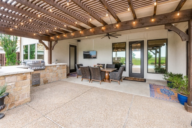 view of patio featuring exterior kitchen, outdoor dining space, a grill, and a pergola