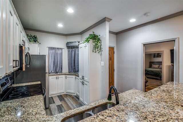 kitchen featuring white cabinetry, sink, light stone countertops, and stainless steel appliances