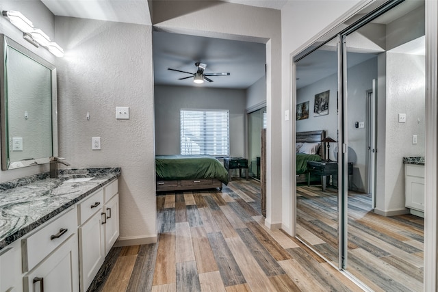 bathroom featuring vanity, ceiling fan, and hardwood / wood-style floors