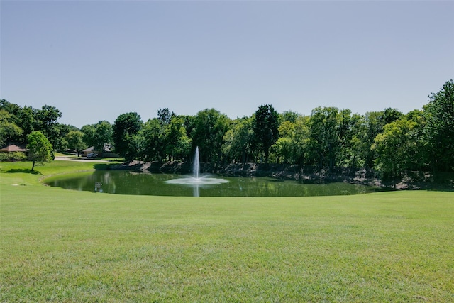 surrounding community with a yard and a water view