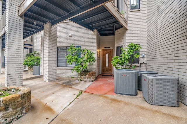 doorway to property featuring central air condition unit