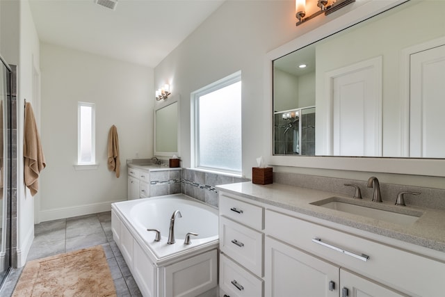 bathroom with tile flooring, a bath, and double vanity