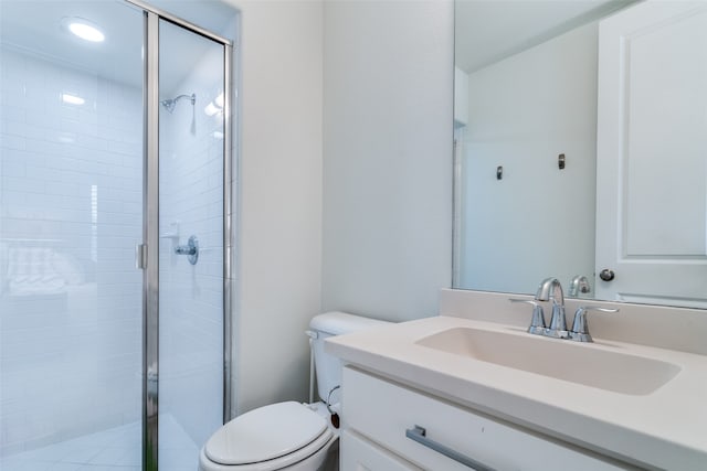 bathroom featuring a shower with door, toilet, and oversized vanity