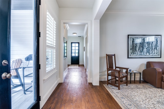 interior space with dark wood-type flooring and crown molding