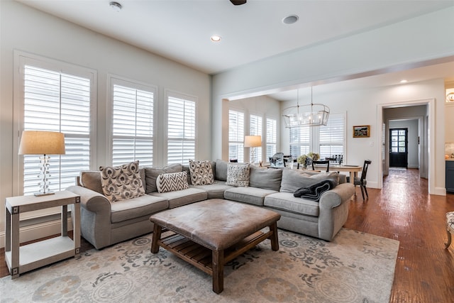 living room featuring a notable chandelier and hardwood / wood-style flooring