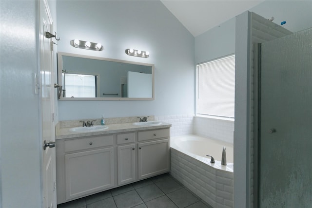 bathroom with plus walk in shower, vanity, tile patterned floors, and lofted ceiling