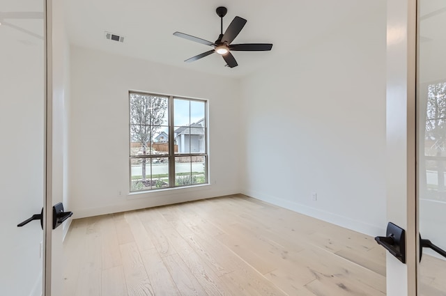 spare room with light hardwood / wood-style floors and ceiling fan