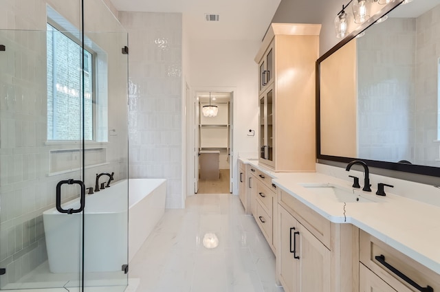 bathroom featuring tile walls, tile patterned flooring, shower with separate bathtub, and vanity