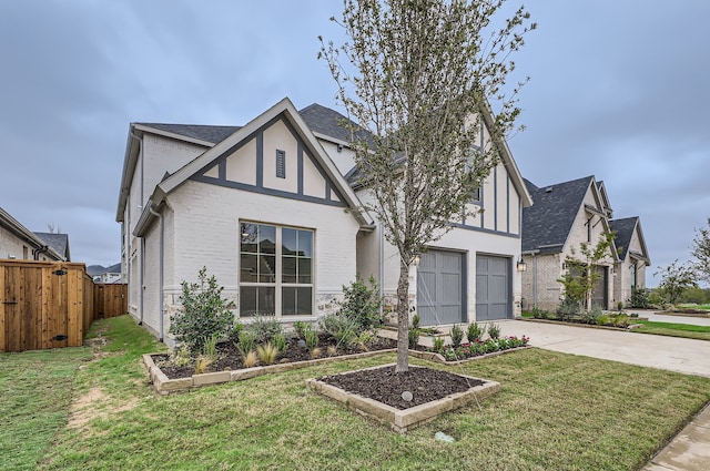 tudor house featuring a front yard and a garage