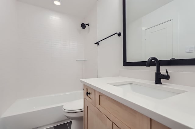 full bathroom featuring tile patterned floors, tiled shower / bath combo, vanity, and toilet