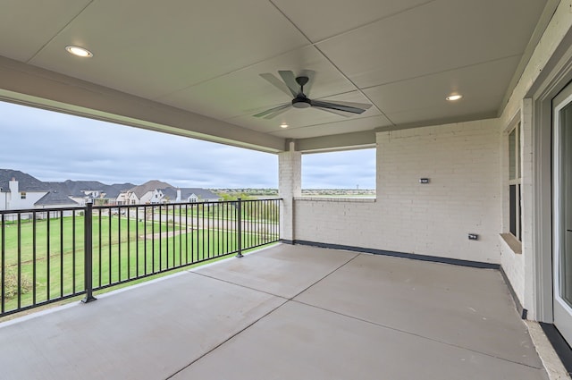 view of patio with a balcony and ceiling fan