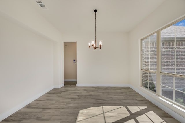 interior space featuring a notable chandelier, plenty of natural light, and hardwood / wood-style floors