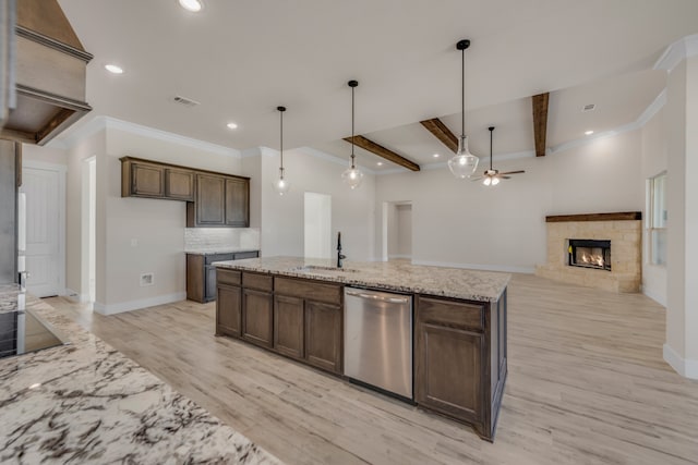 kitchen with pendant lighting, a fireplace, light stone countertops, ceiling fan, and stainless steel dishwasher