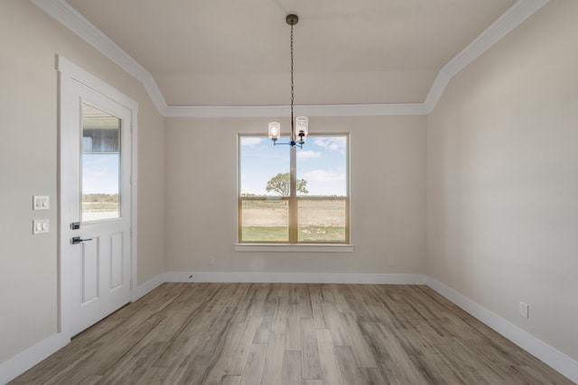 unfurnished dining area with a notable chandelier, light hardwood / wood-style flooring, and crown molding