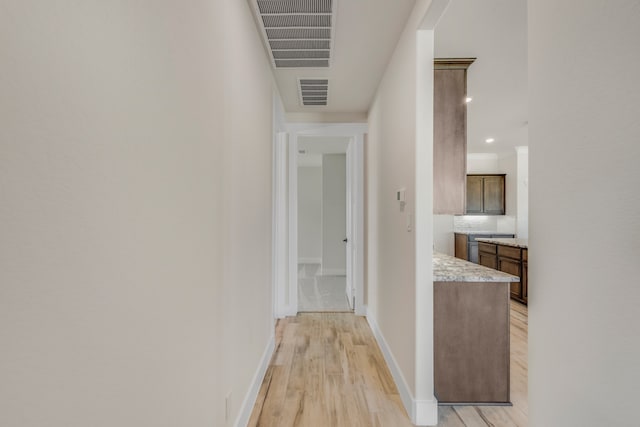 corridor with light wood-type flooring