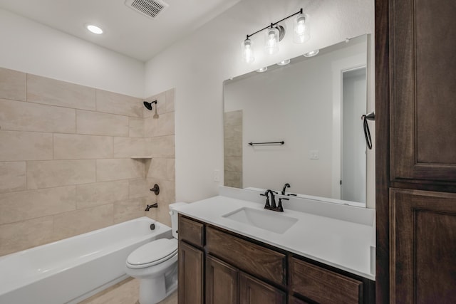 full bathroom with tiled shower / bath combo, vanity, and toilet