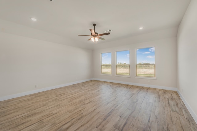 unfurnished room with light wood-type flooring and ceiling fan