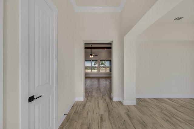 hall featuring crown molding and light hardwood / wood-style floors