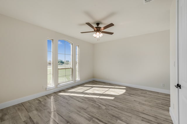 spare room with ceiling fan and light wood-type flooring