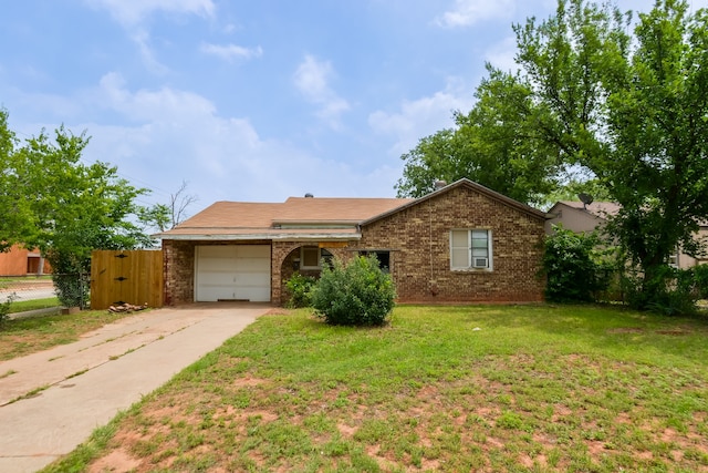 single story home featuring a garage and a front lawn