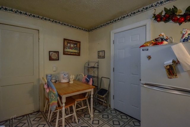 dining room with a textured ceiling