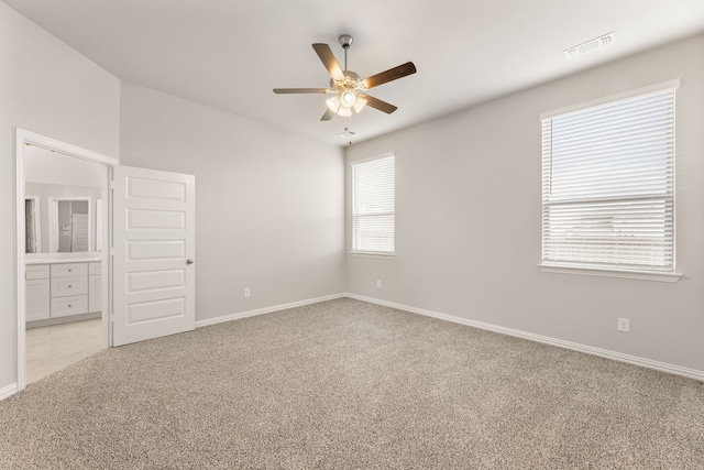 unfurnished bedroom with ceiling fan, baseboards, visible vents, and light colored carpet