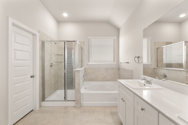 bathroom with a stall shower, a garden tub, vanity, and tile patterned floors