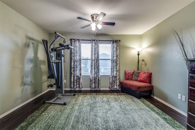 workout room featuring dark hardwood / wood-style floors, a textured ceiling, and ceiling fan