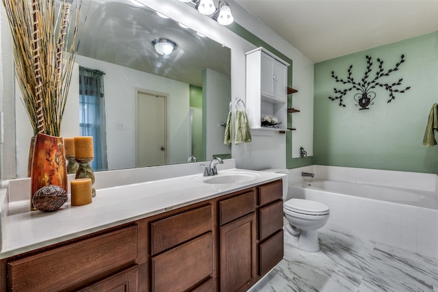 bathroom with vanity, toilet, and tiled tub