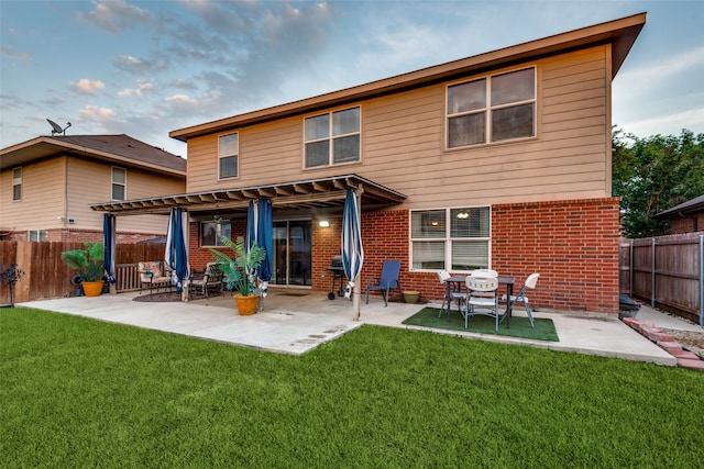 rear view of property with a patio and a lawn