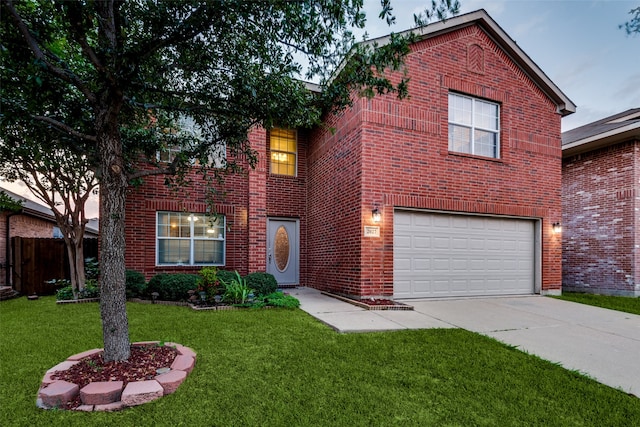 view of front property featuring a garage and a lawn