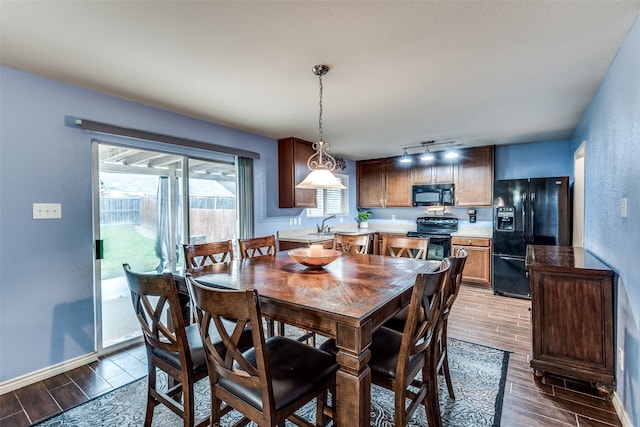 dining area with sink and hardwood / wood-style floors