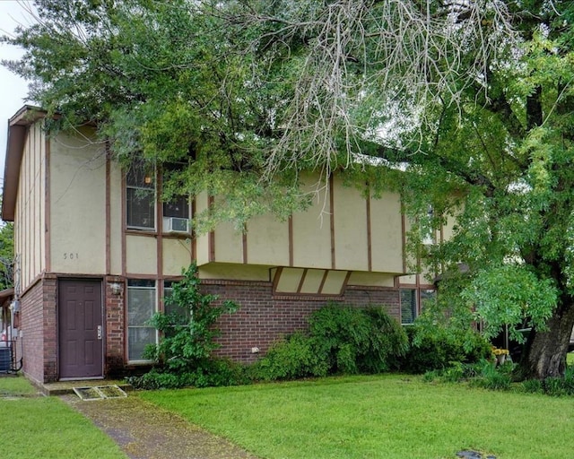 exterior space with central AC and a front yard