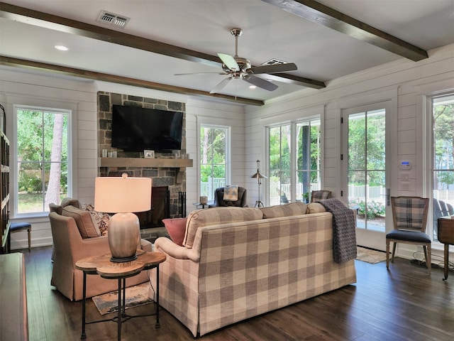 living room with plenty of natural light and dark hardwood / wood-style flooring