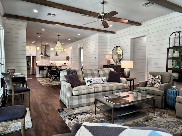 living room with wooden walls, ceiling fan, beam ceiling, and dark hardwood / wood-style floors